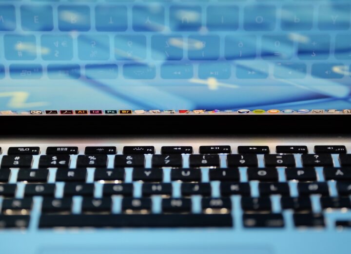 Legislative document and computer with software code representing California budget trailer bill