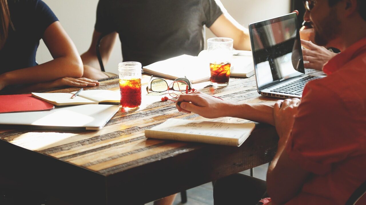 Business professionals working with AI agents on digital devices