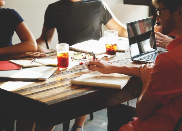 Business professionals working with AI agents on digital devices
